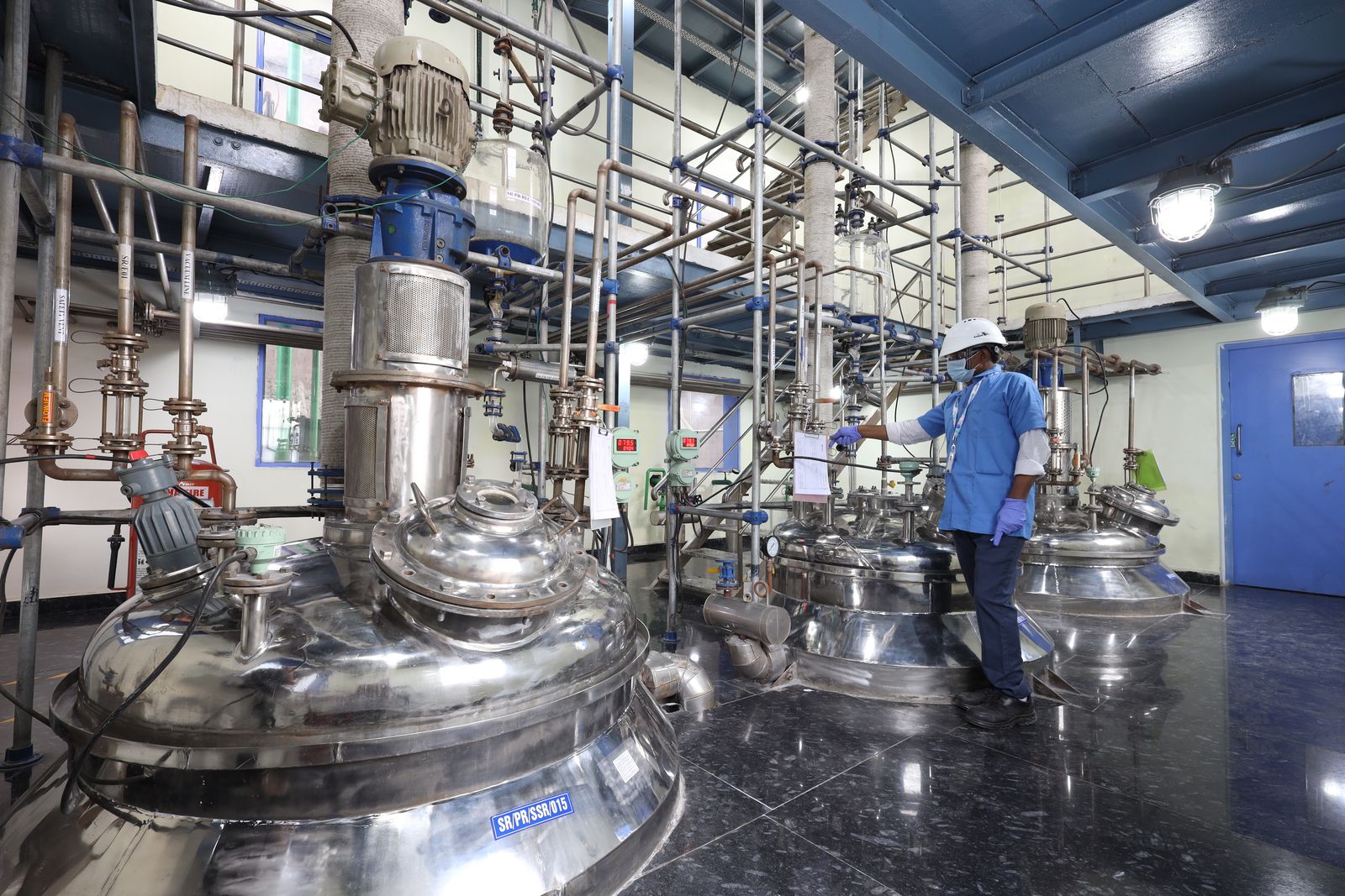 Operator recording batch readings at the stainless steel reactor line, SRPL Hyderabad