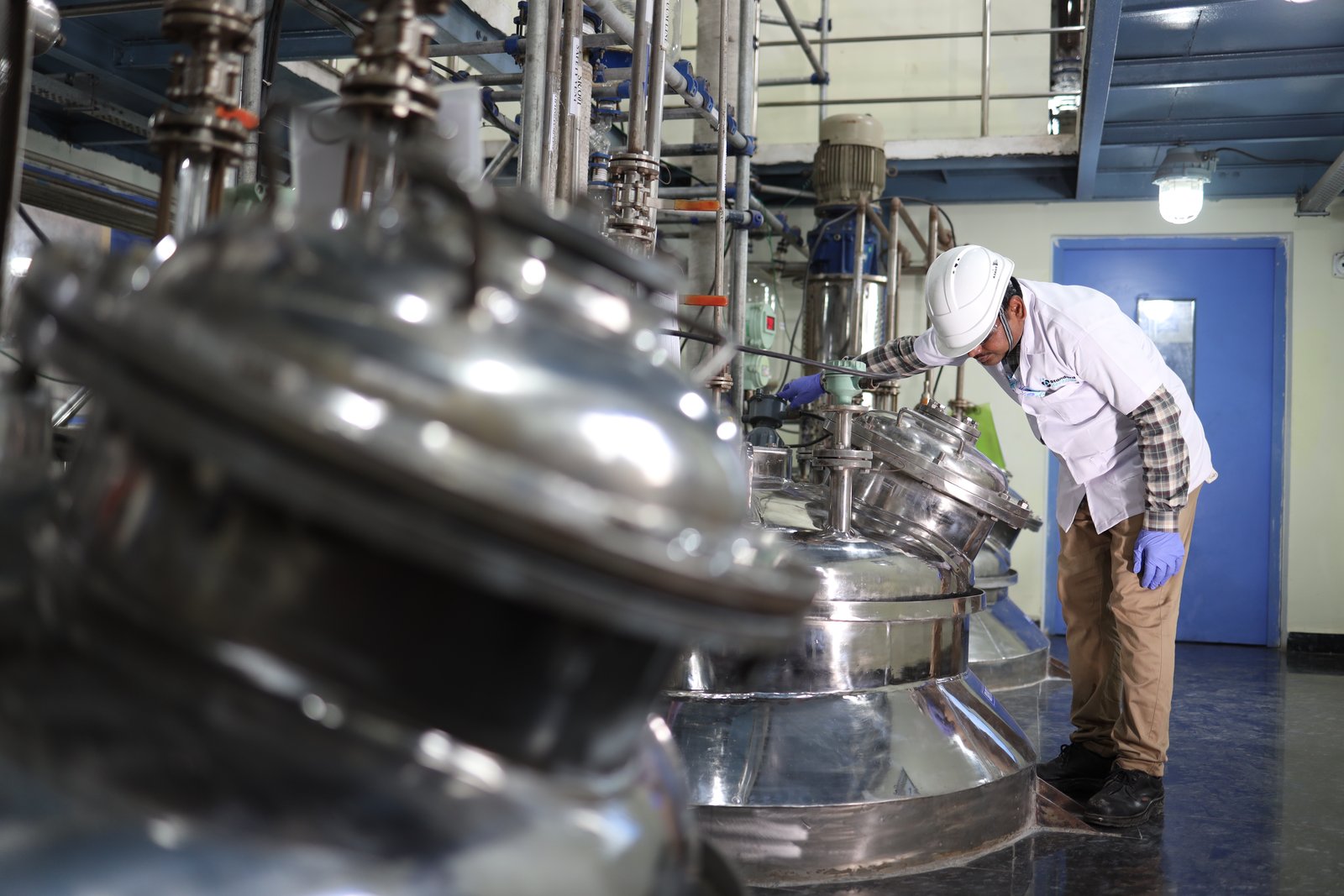 Operator performing in-process checks at the SRPL reactor line